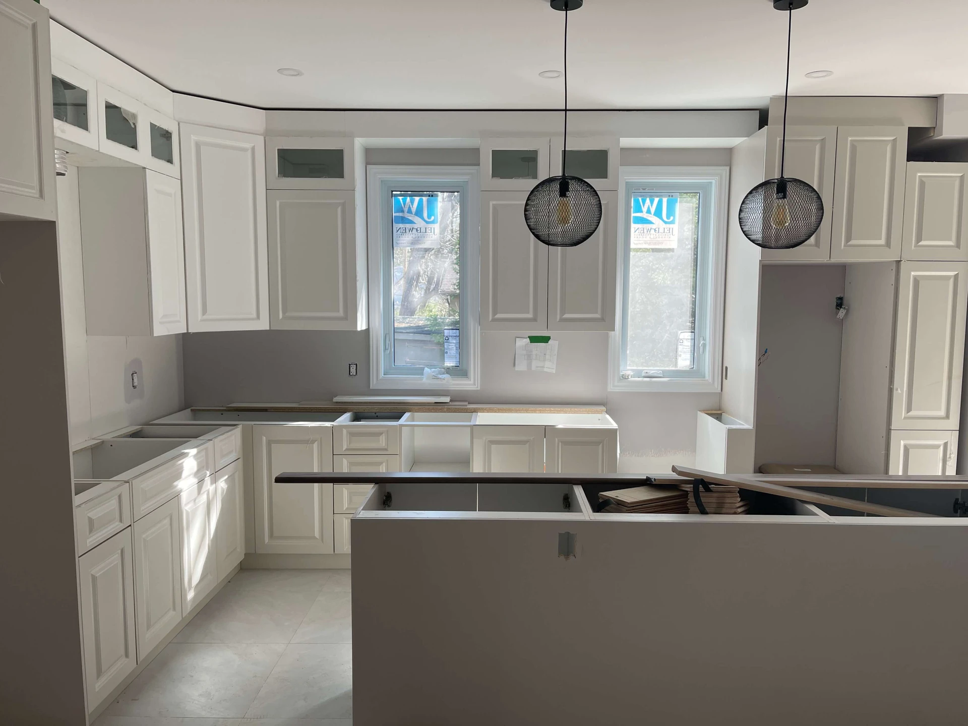 White kitchen renovation with pendant lights